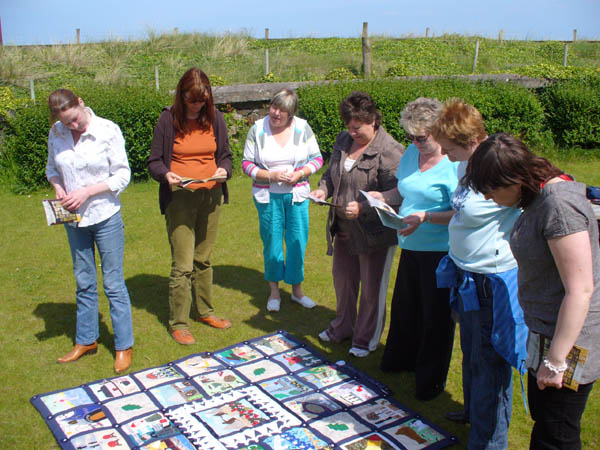Women engrossed in a quilt at the workshop in Downhill Hostel, County Derry, 31st May 2007, in preparation for the 2008 exhibition: 