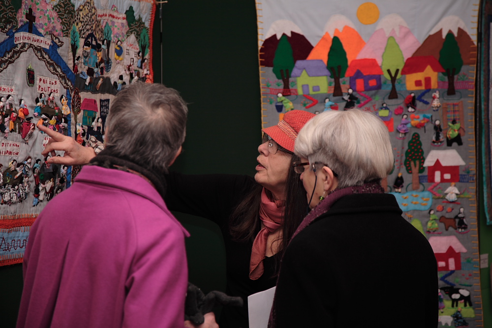 Curator Roberta Bacic sharing a detail of the arpillera 