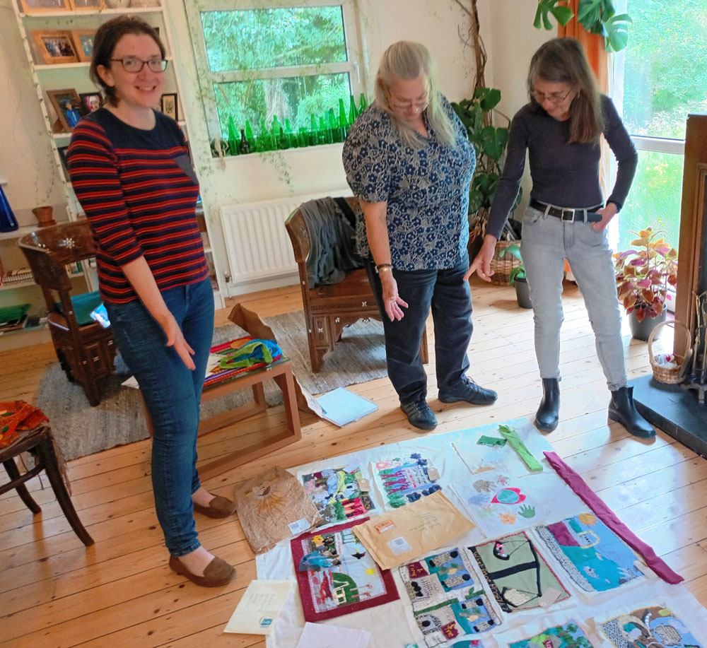 Jeannie McCann,Trócaire, Deborah Stockdlae and Roberta Bacic, Conflict Textiles, in the process of assembling the collective 'Threads for Corporate Justice' banner; the outcome of 3 workshops facilitated by Deborah and Roberta.  (Photo: Clem McCartney)