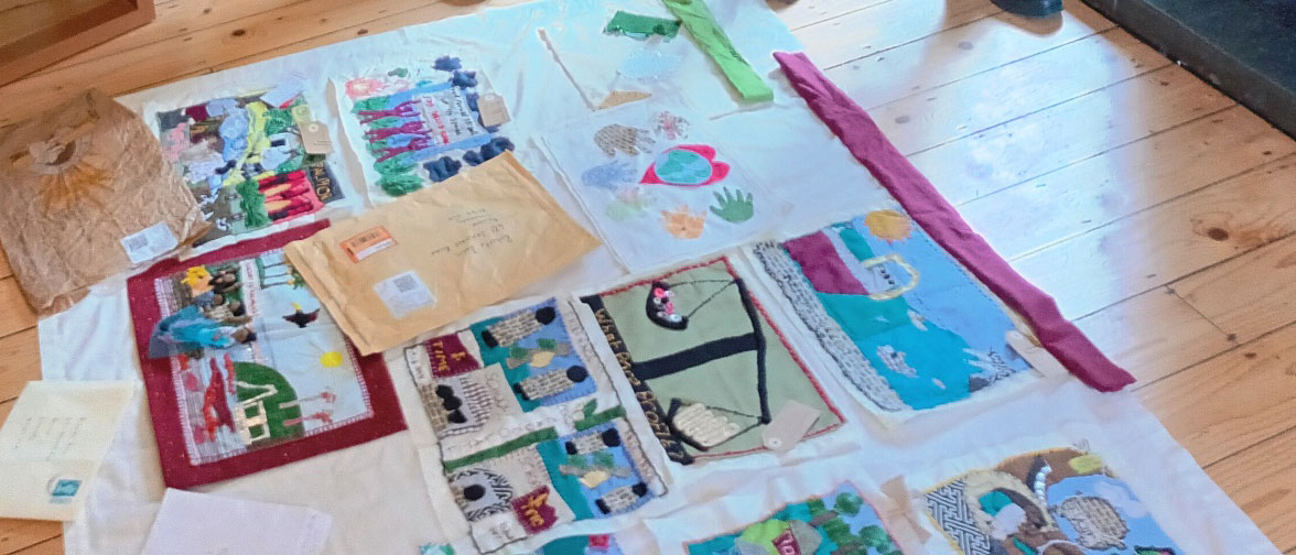 'Threads for Corporate Justice', by Trócaire activists participating in online workshops facilitated by Conflict Textiles. (Photo showing banner assembly process: Clem McCartney)