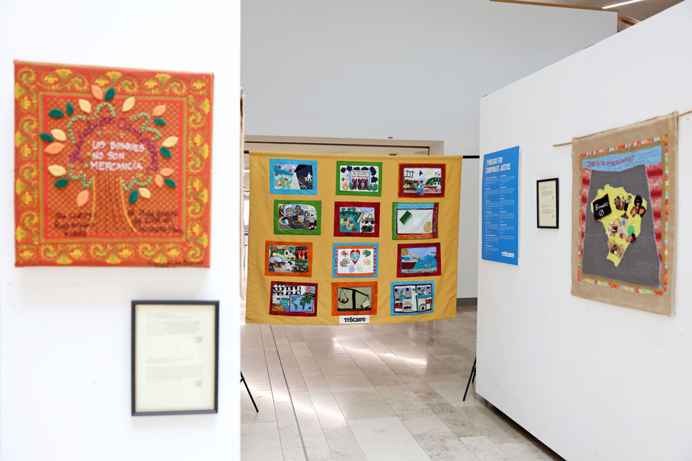 `Threads for Corporate Justice' collective banner on display in the Birely Building, Ulster University, Belfast, with other pieces from Conflict Textiles collection. (Photo: Justin Kernoghan)
