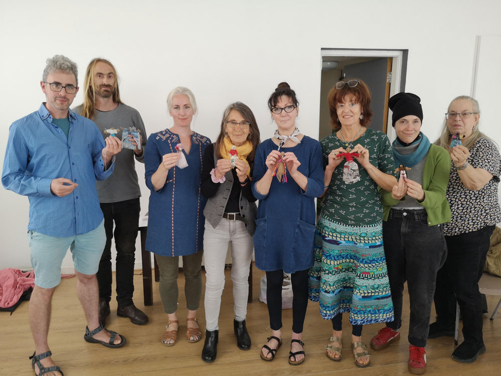 Members of ^ artist collective with the arpillera dolls they created in the 'Waking the Land' workshop facilitated by Conflict Textiles curator Roberta Bacic, 11th July 2023.  (Photo: Rachel Wetherall)