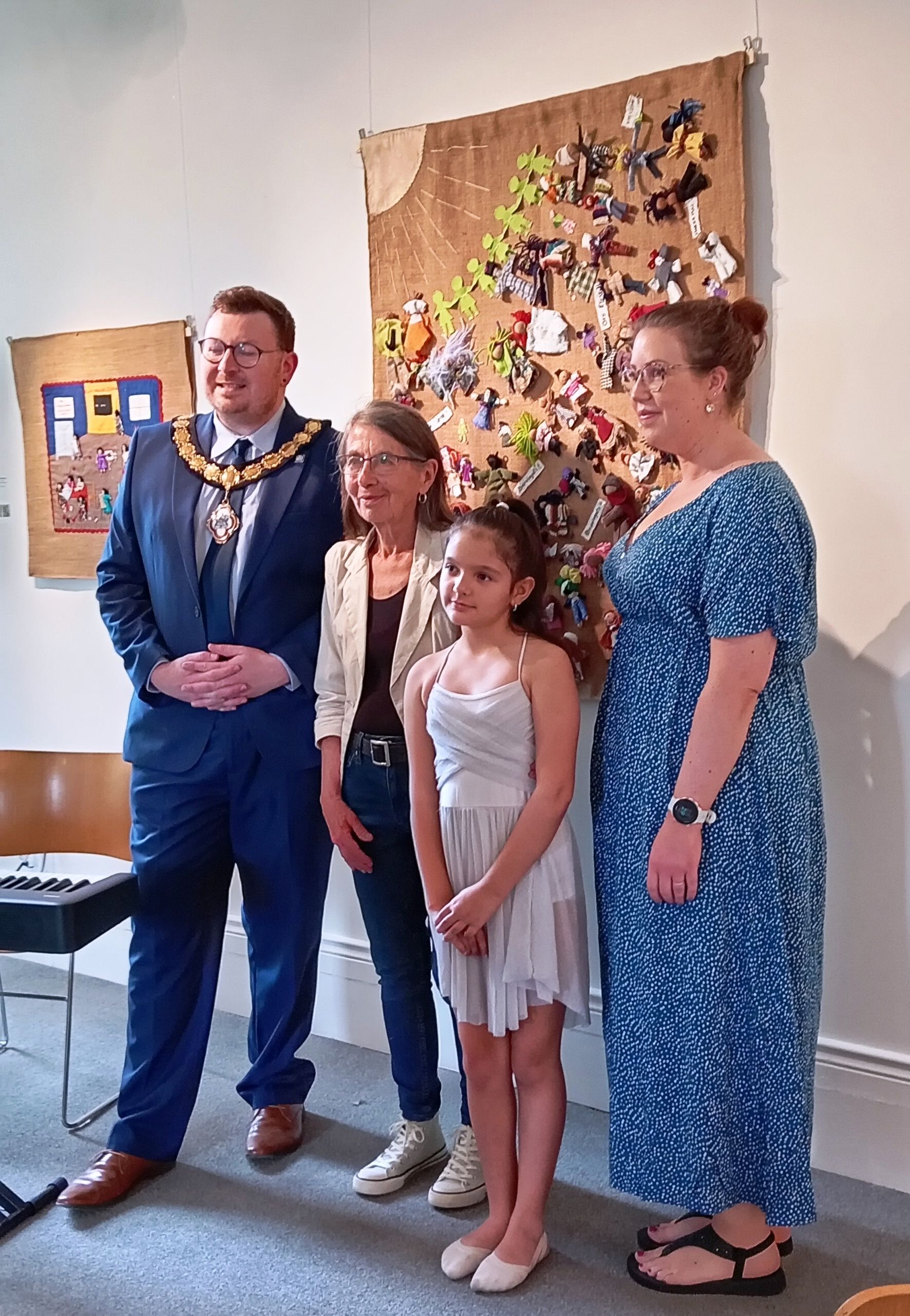 Alderman Richard Stewart (Deputy Mayor of Causeway Coast and Glens Borough Council), Roberta Bacic (Conflict Textiles Curator), Amaranta Rojas (Chilean Dancer) and Sarah Calvin (Museum Services Development Manager) at the opening of Refugee Week 2025