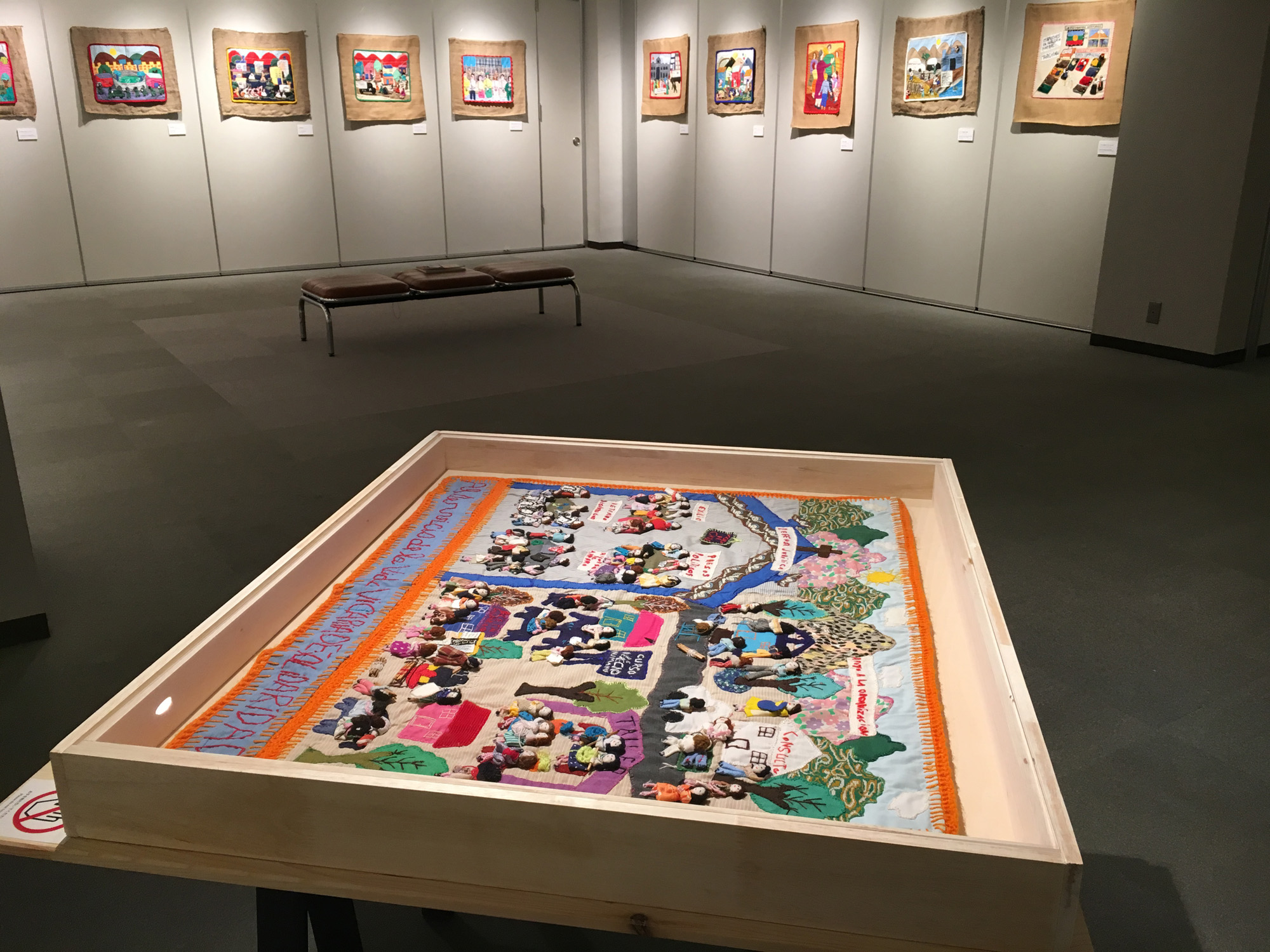 A selection of arpilleras on display at the 'Stitching Memoryscape 「記憶風景を縫う」' exhibition, Sendai, Japan.